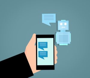 A cartoon hand holds a cellphone which is having a conversation with a chatbot.