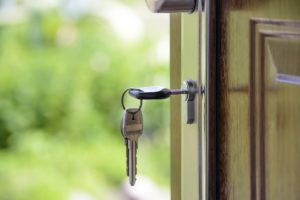 Keys dangling in a door lock, representative of a property being rented
