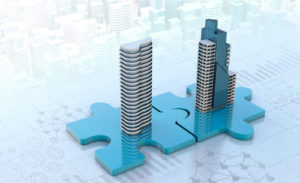 Two tall buildings on top of puzzle pieces fit together, representing property management business acquisition