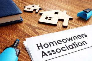 Papers that read Homeowners Association with cutouts of homes