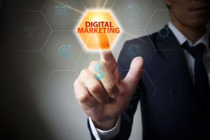 Person in suit clicks on a button highlighting the words 'Digital Marketing'.