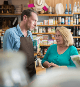Grocery Clerk Helping Customer